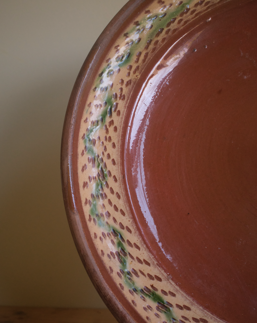 A large terracotta plate with decorative border