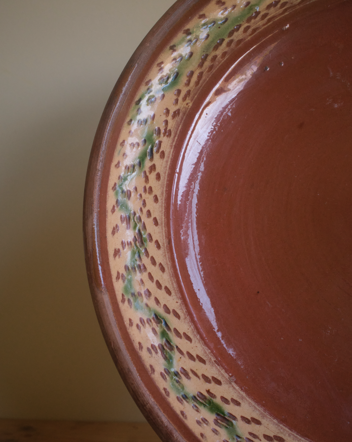 A large terracotta plate with decorative border