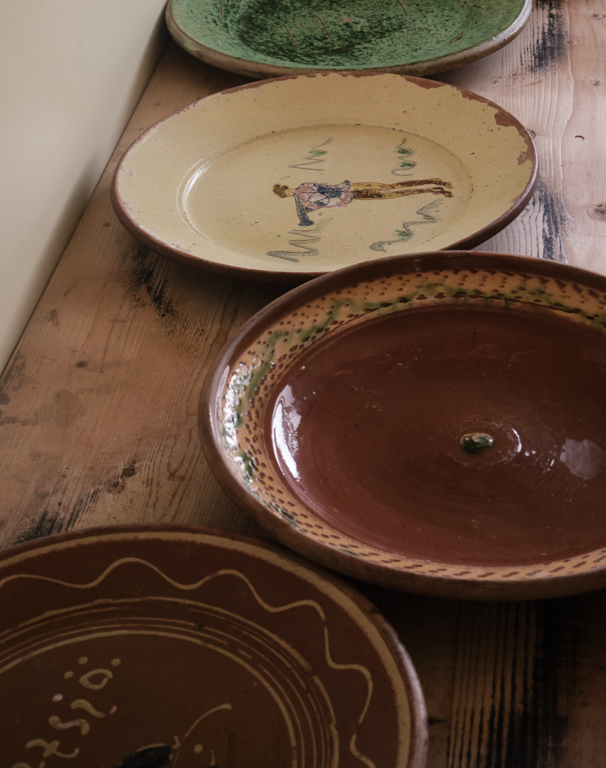 A large terracotta plate with decorative border