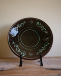 A large green Swedish decorative plate